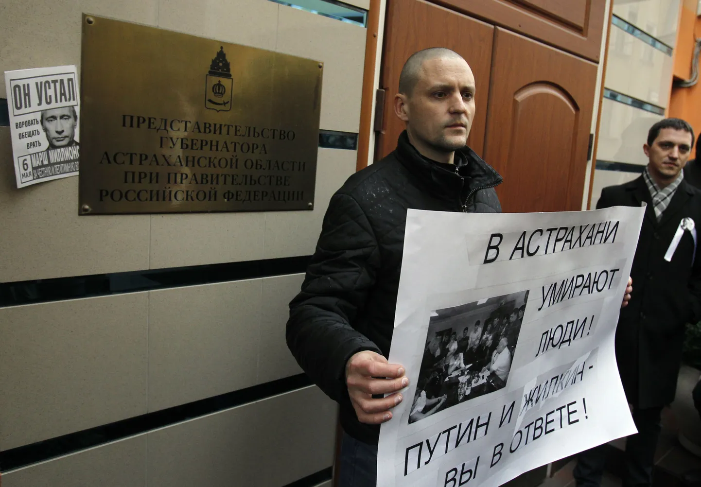 Vene üks opositsioonijuhte Sergei Udaltsov hoidis täna Moskvas toimunud piketil plakatit loosungiga: «Astrahanis inimesed surevad! Putin ja [Astrahani oblasti kuberner] Žilkin, teie vastutate!»