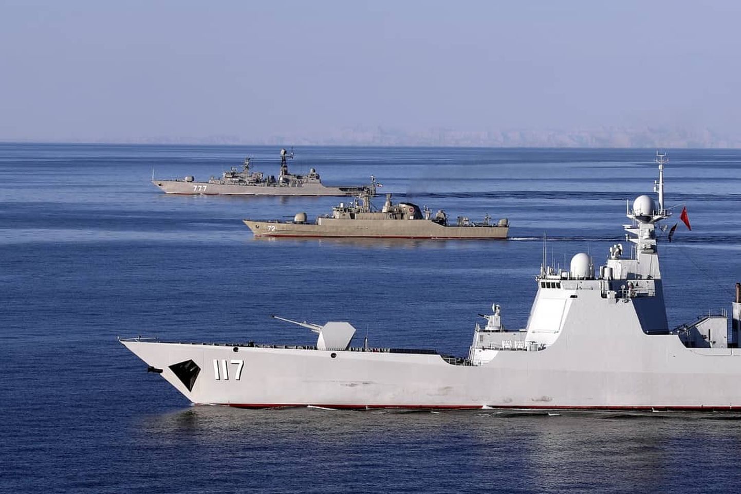 A handout photo made available by the Iranian Army office on December 28, 2019 shows a view of the Chinese People's Liberation Army Navy Surface Force Type 052D destroyer Xining (117), the Islamic Republic of Iran Navy frigate "ALBORZ" (72), and the Russian Navy Neustrashimyy-class frigate "Yaroslav Mudry" during joint Iran-Russia-China naval drills in the Indian Ocean and the Gulf of Oman. - Iran, China and Russia started four days of joint naval drills in the Indian Ocean and the Gulf of Oman, the commander of Iran's flotilla announced. The exercise comes at a time of heightened tensions since the United States withdrew from a landmark 2015 nuclear deal with Iran in May 2018. (Photo by HO / Iranian Army office / AFP) / === RESTRICTED TO EDITORIAL USE - MANDATORY CREDIT "AFP PHOTO / HO / Iranian Army office" - NO MARKETING NO ADVERTISING CAMPAIGNS - DISTRIBUTED AS A SERVICE TO CLIENTS ===