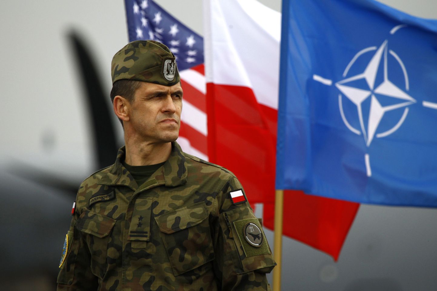 Poola sõdur USA, Poola ja NATO lippude ees.