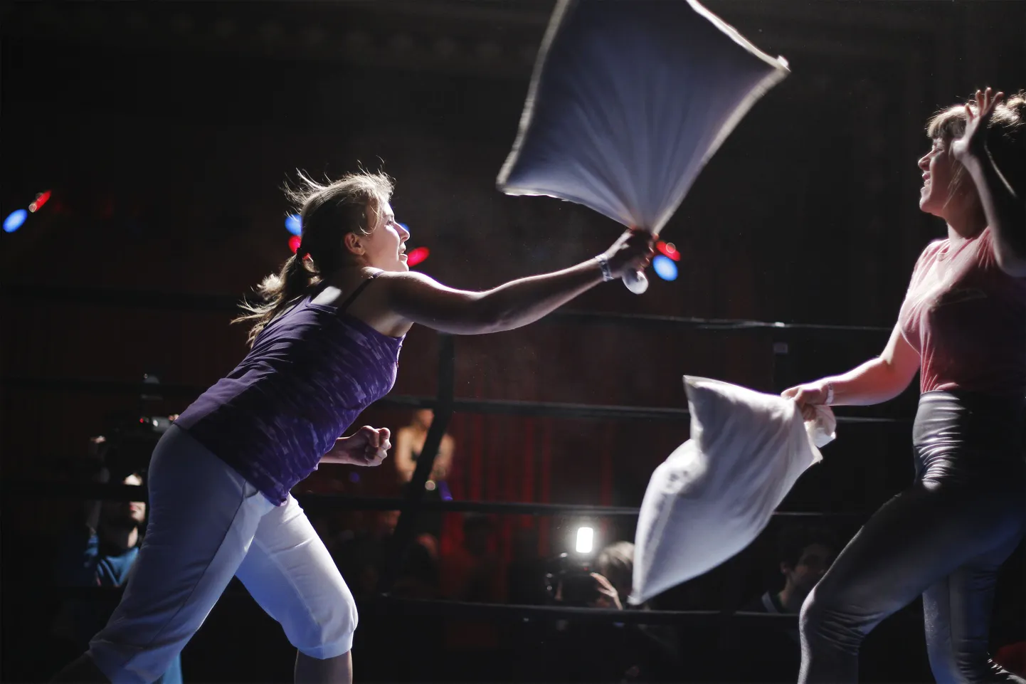 Katharina Merkle (L) of Austria hits Jen Tullock of the U.S. in the preliminary round of the first Pillow Fighting World Championships in New York May 17, 2011.  REUTERS/Lucas Jackson  (UNITED STATES - Tags: SOCIETY)
