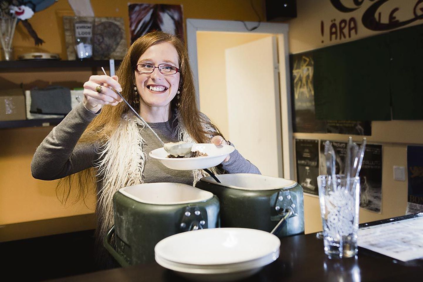 Pärnu noorte vabaajakeskuse noorsootöötaja Triin Mäger ulatamas tatart soustiga. Keskus pakub koolivaheajal tööpäeviti lastele ja noortele sooja toitu, mille on valmistanud Riia söögituba.