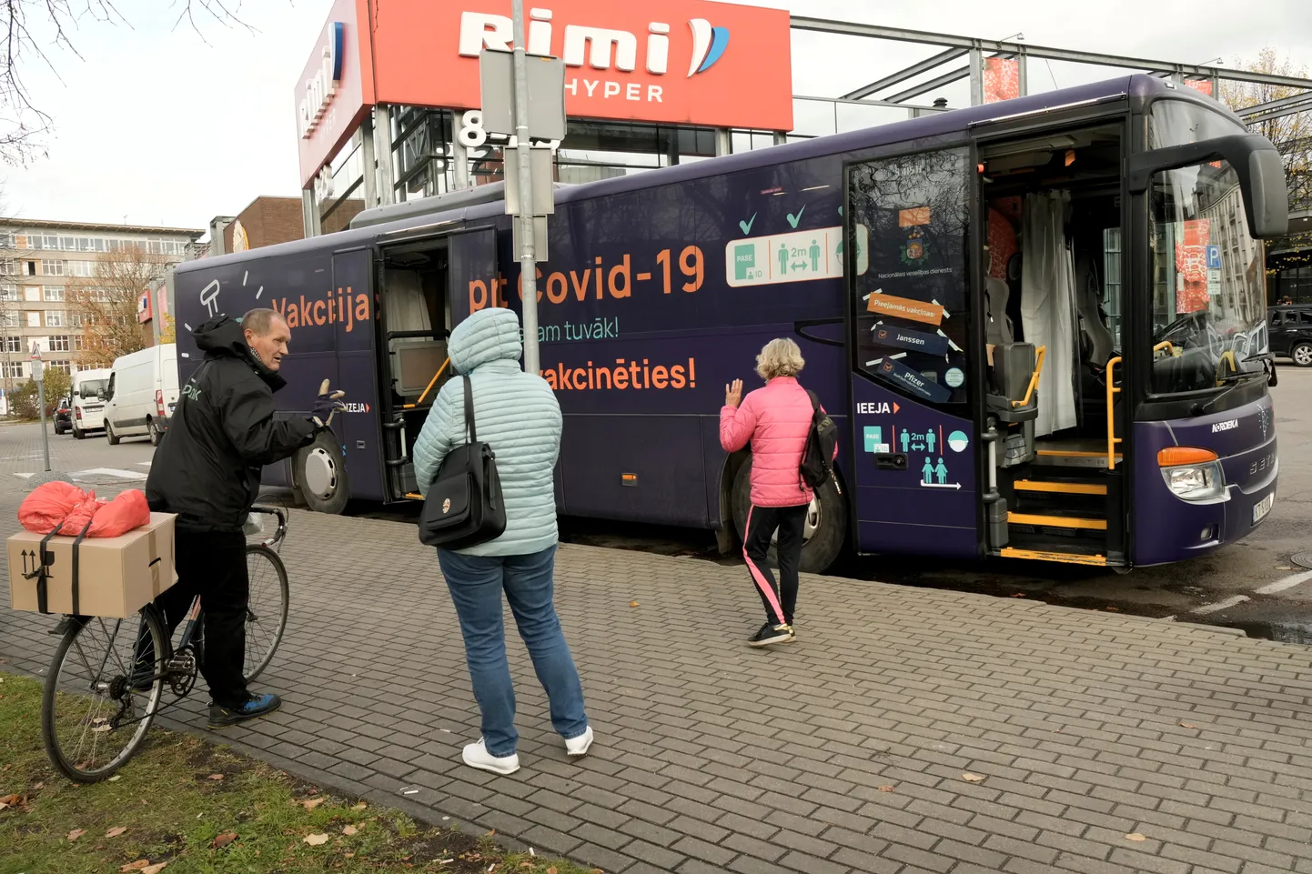 «Meie oleme lähemal» ning «Tulge vaktsineerima.» Inimesed ootamas Riias mullu 19. oktoobril, et vaktsineerimisbussis kaitsesüst kätte saada.