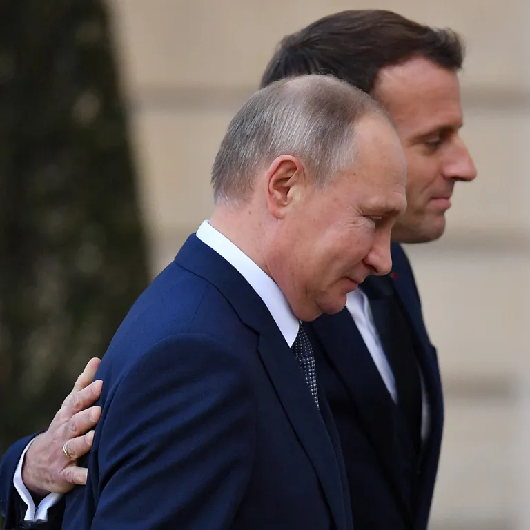 Президент Франции Эмманюэль Макрон приветствует Путина в Париже, декабрь 2019 года.