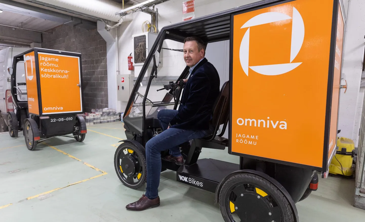 Глава Eesti Post Март Мяги за «рулем» электрического грузового велосипеда.