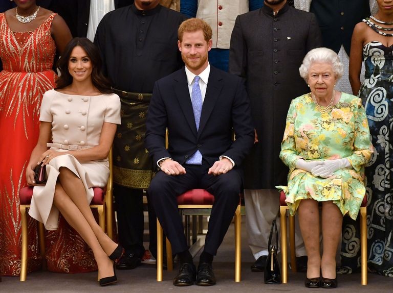 Королева Елизавета II, принц Гарри и Меган Маркл в 2018 году в Лондоне.
