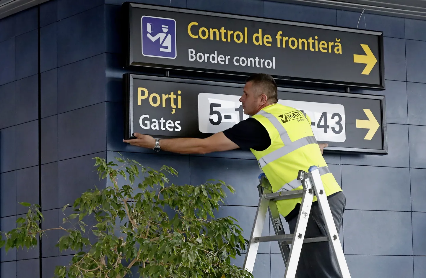 Bukaresti Henri Coandă rahvusvahelise lennujaama töötaja vahetamas silte enne Rumeenia ja Bulgaaria osalist ühinemist Schengeni alaga pühapäeval, 31. märtsil 2024.