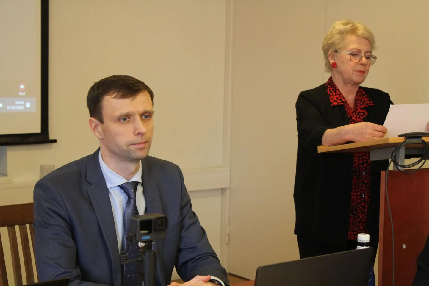 Leelo Jürimaa loeb ette umbusaldamise algatamise teksti. Maksim Butšenkov kuulab vaikides.