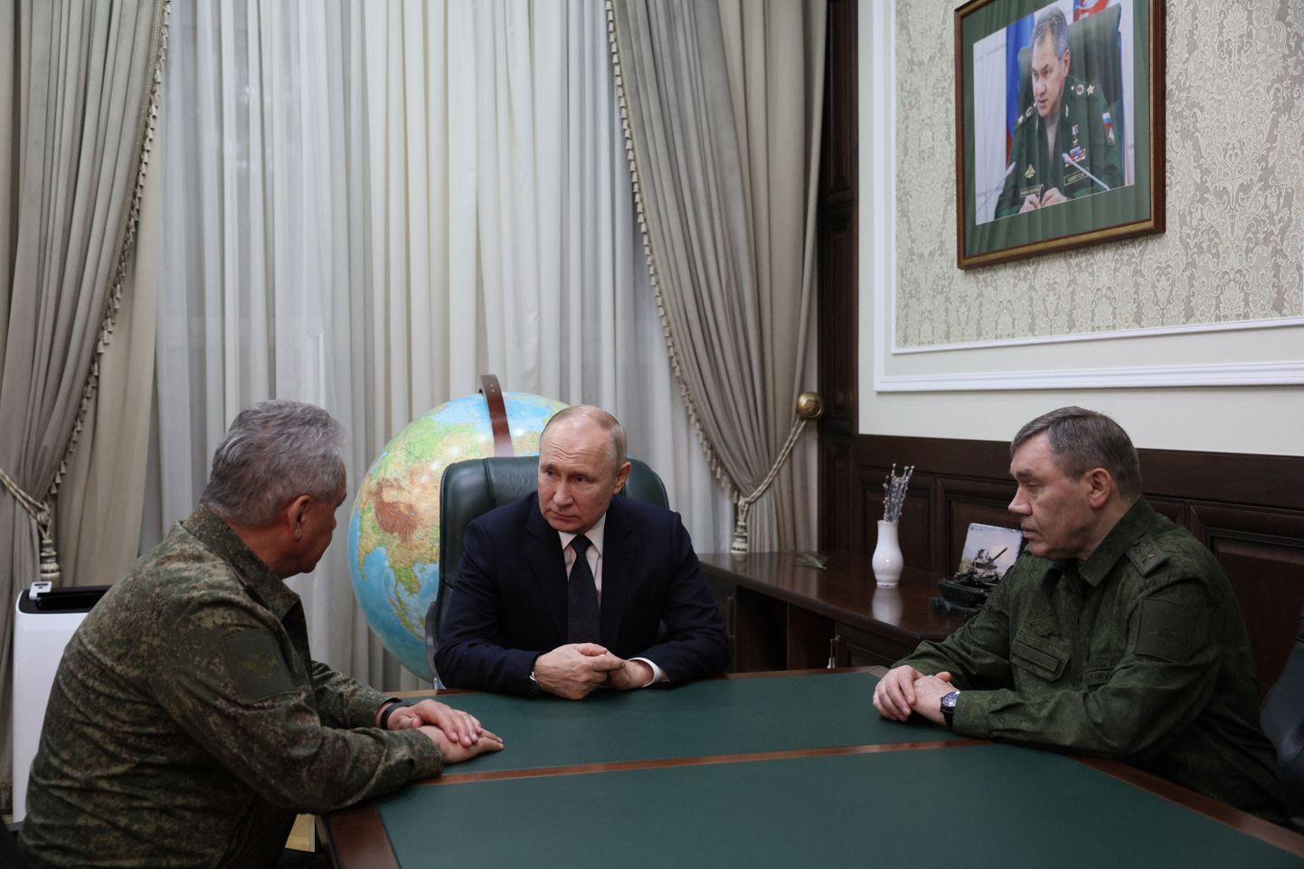 Президент России Владимир Путин беседует с министром обороны Сергеем Шойгу (слева) и начальником Генерального штаба Валерием Герасимовым.