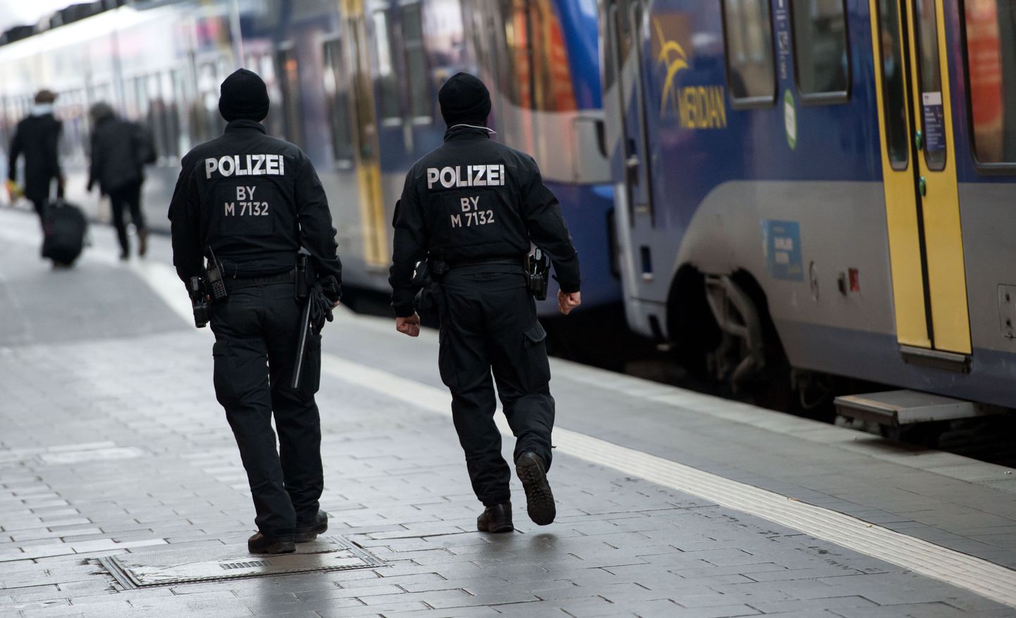Police patrol at the main railway station in Munich, southern Germany, Saturday, Jan. 2, 2016. Police are maintaining a heightened presence following warnings of a planned attack on New Year's Eve. (Sven Hoppe/dpa via AP)