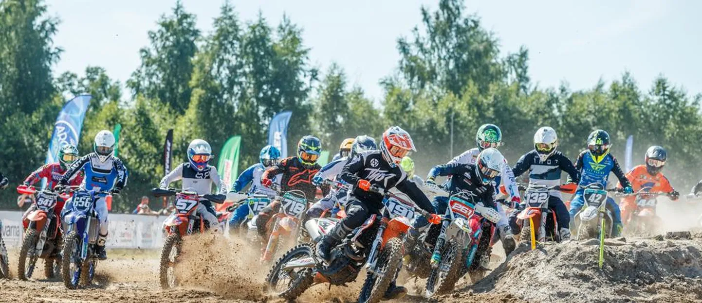 Krossisõitjad sööstavad Pärnu lennuvälja motopargi raja esimesse kurvi.