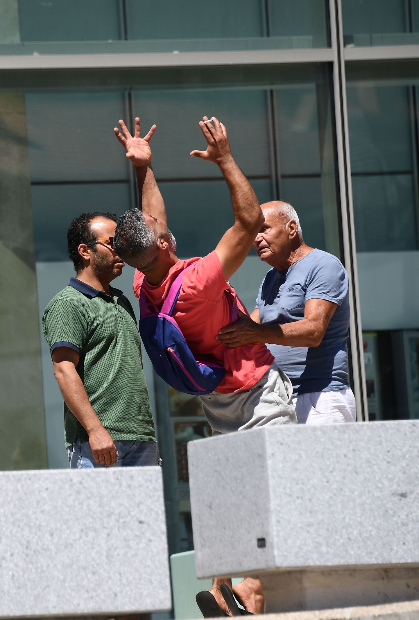 Tahar Mejri (C), who lost his wife during the deadly Nice attack that left 84 dead on Bastille day, yells in front of the Pasteur hospital in the French riviera town of Nice after he found out the death of his son on July 16, 2016.
The Islamic State group claimed responsibility for the truck attack that killed 84 people in Nice on France's national holiday, a news service affiliated with the jihadists said Saturday. Tunisian Mohamed Lahouaiej-Bouhlel, 31, smashed a 19-tonne truck into a packed crowd of people in the Riviera city celebrating Bastille Day -- France's national day. / AFP PHOTO / ANNE-CHRISTINE POUJOULAT