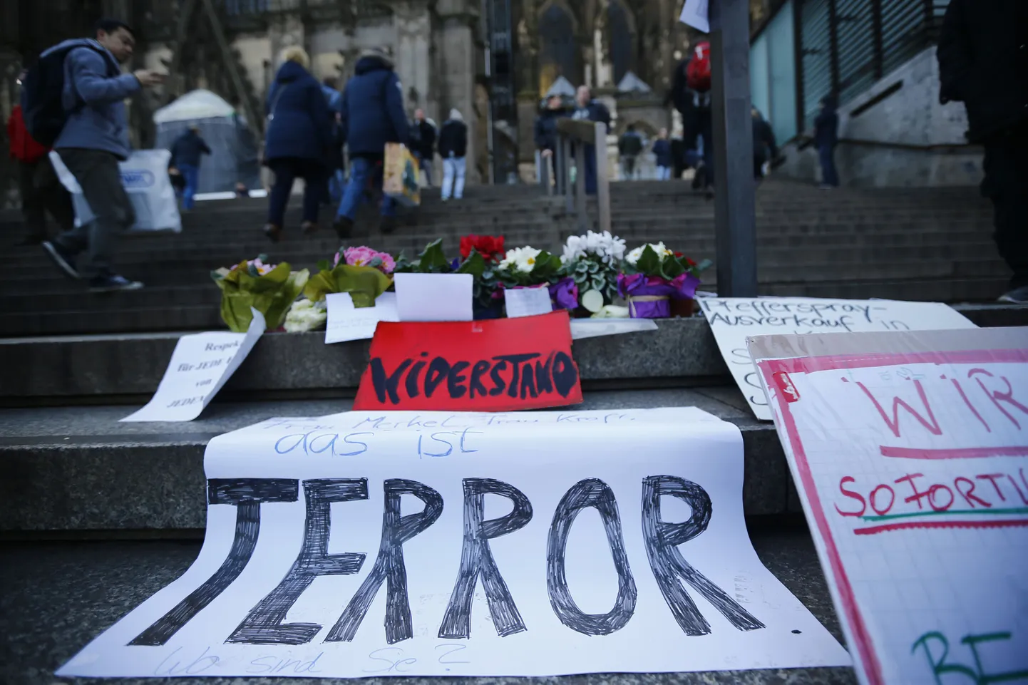 A placard reading 'Mrs Merkel, Mrs Kraft, this is terror. Where are you?' lies on the steps to Cologne Cathedral prior to a demonstration by anti-immigration right-wing movement PEGIDA (Patriotic Europeans Against the Islamisation of the West) in Cologne, Germany, January 9, 2016.  REUTERS/Wolfgang Rattay