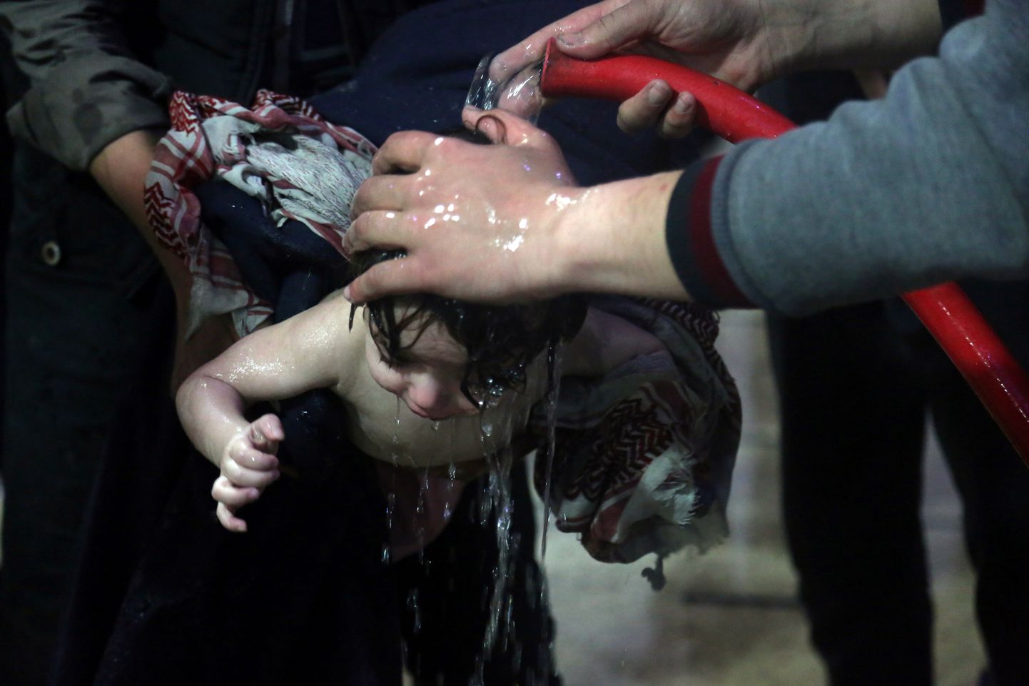 Laps Douma linnas arvatava keemiarünnaku järel humanitaartöötajatelt abi saamas.